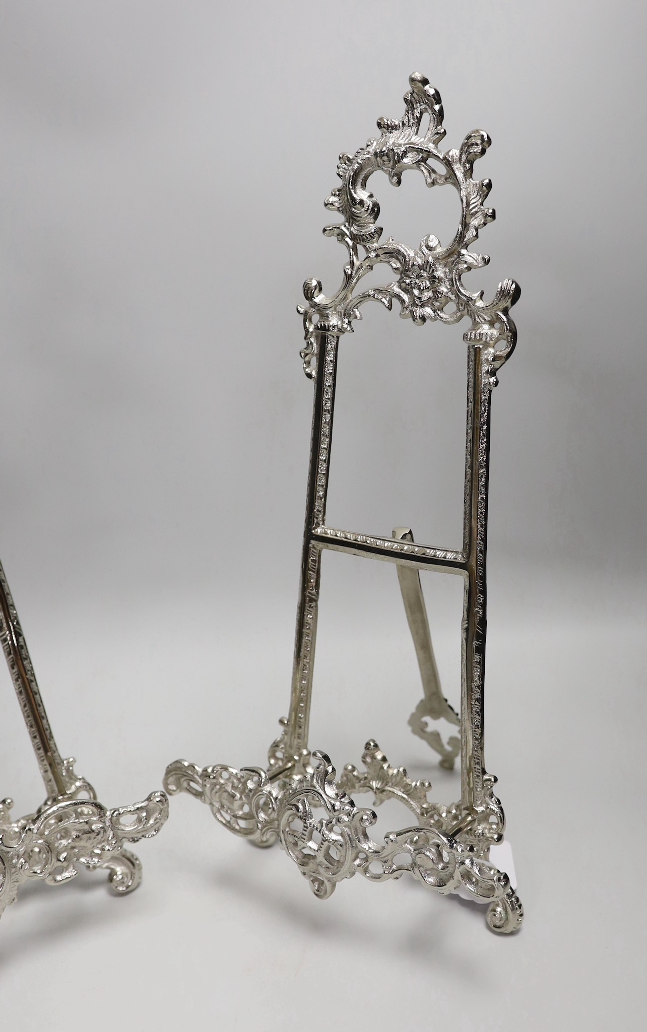 A pair of silver plated Rococo style easels, 41cm